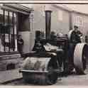 29-114 Steam Road Roller outside 18 Bushloe End with Emma Holt nee Bates in shop doorway c 1940