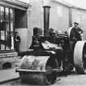 29-114a Steam Road Roller outside 18 Bushloe End with Emma Holt nee Bates in shop doorway c 1940