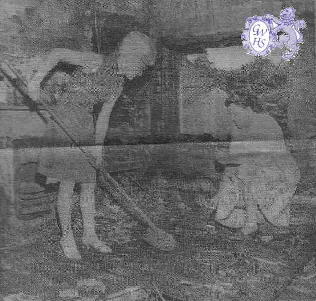 23-801 Penny Hallam and Mary Moss clearing up after the fire in June 1964