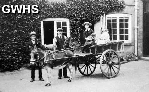 7-104 The Rolleston Family at Glen Parva Grange 1905 Clarice Clover and Dorothy Wright in the cart with John Wright holding the donkey