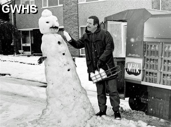 39-338 Milkman Ian Ellis could not resist offering a little of the milk of human kindness to the cold-hearted traffic policeman on Winslow Drive in Wigston, in January 1986